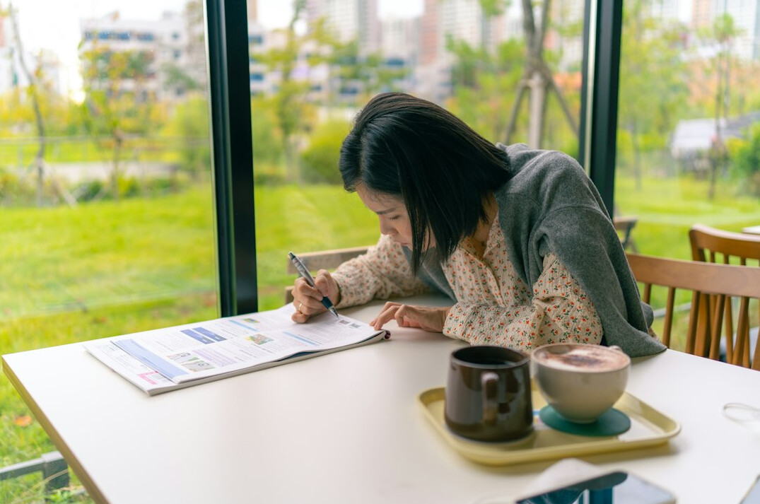 person journaling in cafe