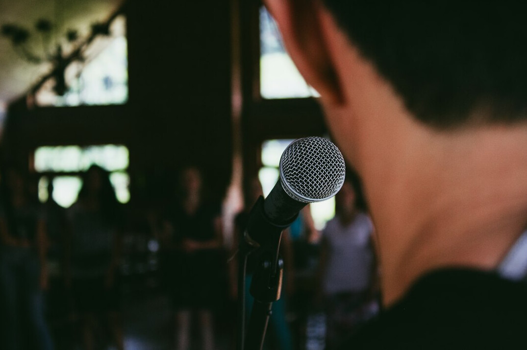 person giving speech on stage